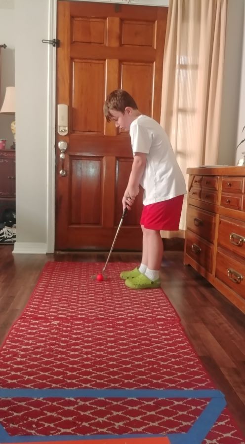 First Tee golfer with homemade golf course